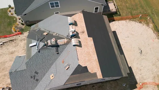 Contractor working on roof edge and flashings